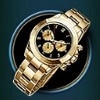 Die Armbanduhr und das Cognacglas mit Zigarre